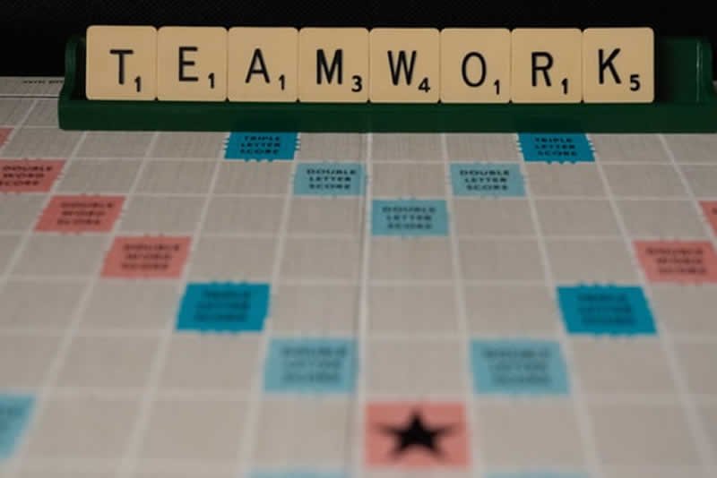 scrabble letters spelling out teamwork